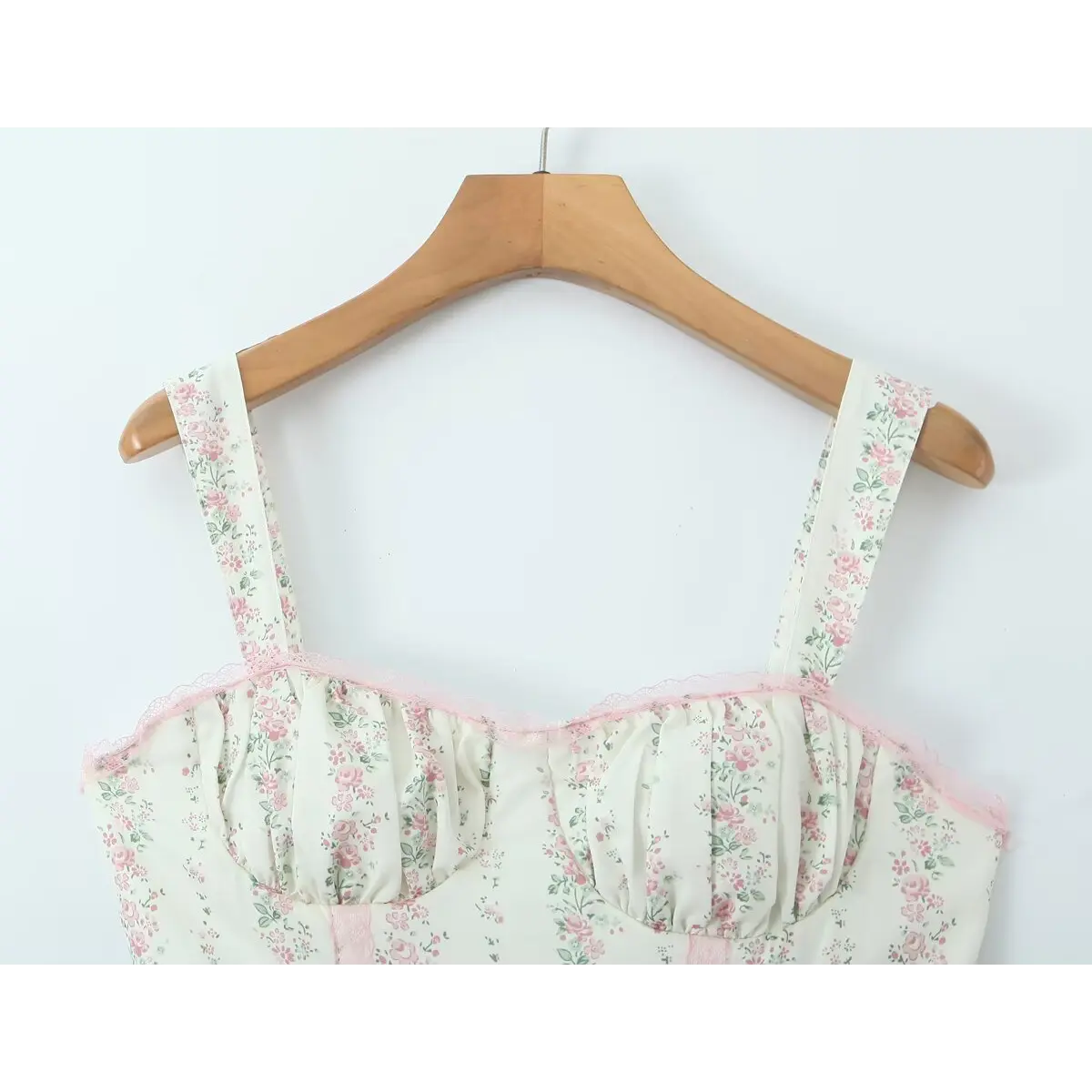 Close-up of the square neckline, pink lace trim, and corset-style bust cups.