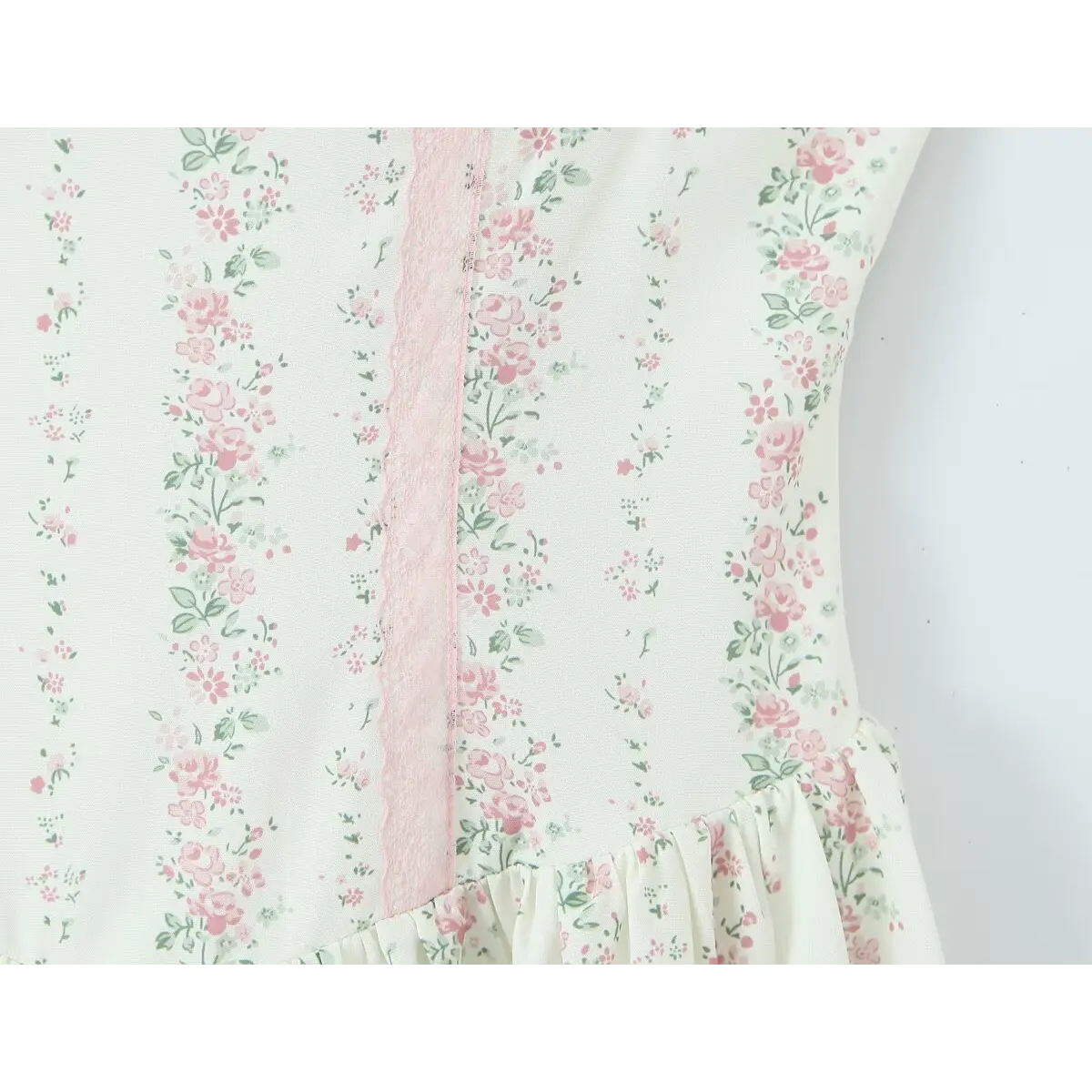 Close-up of the waist seam, showing the pink lace panel and transition to the gathered skirt.