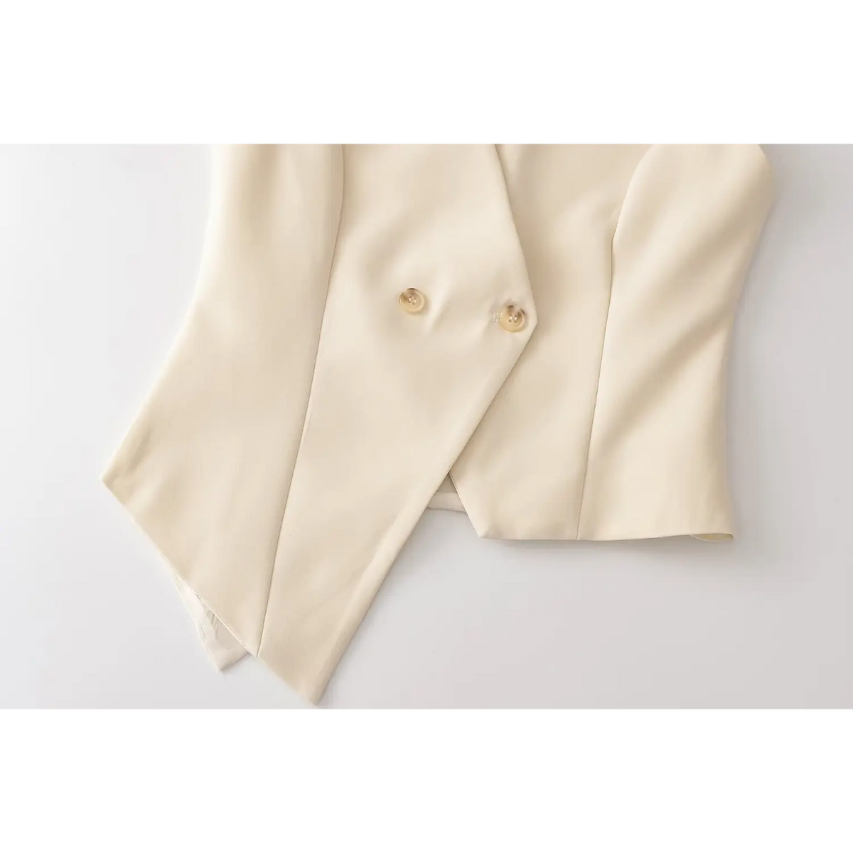 Close-up of double breasted buttons and asymmetric hem