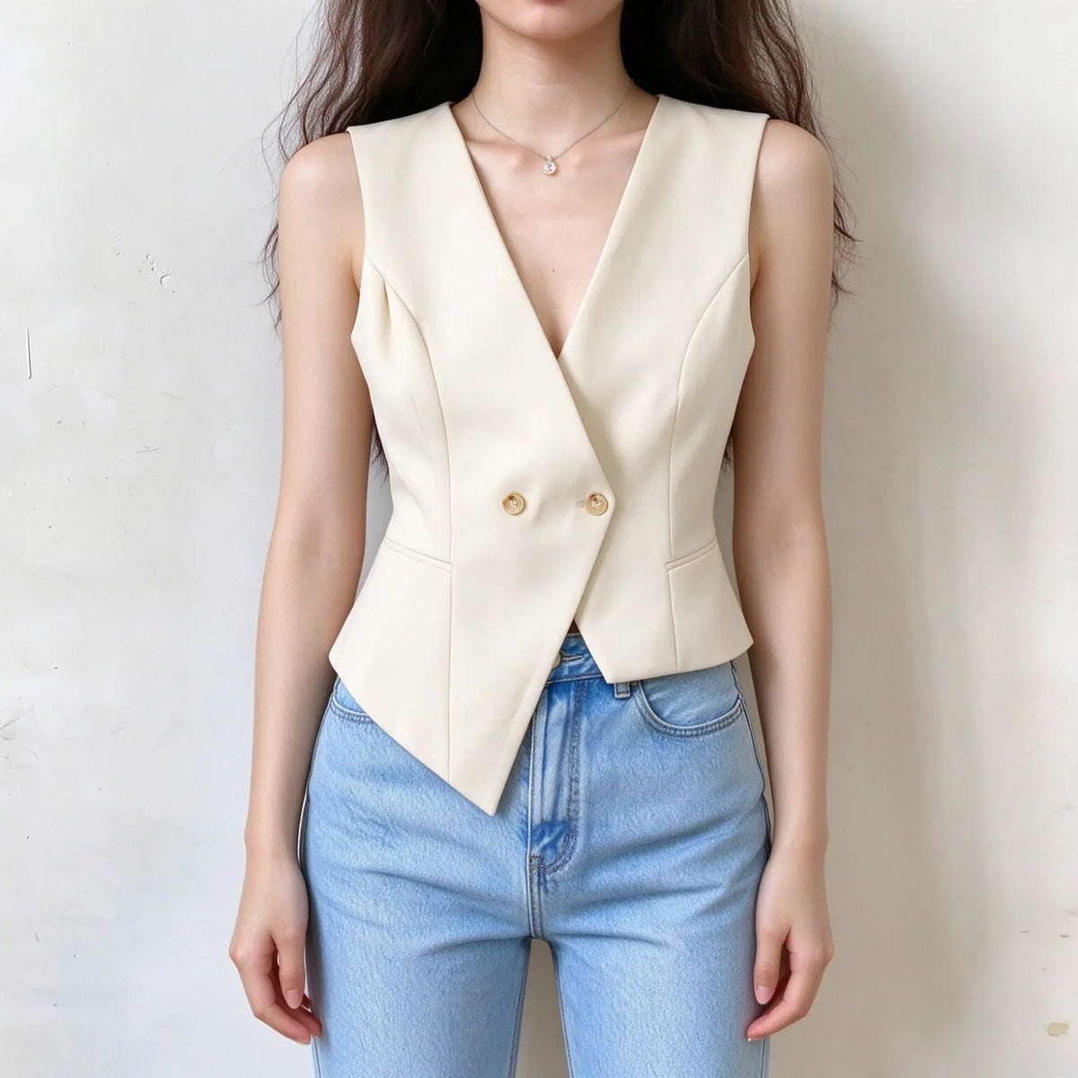 Model wearing cream double breasted v neck tailored vest, front view