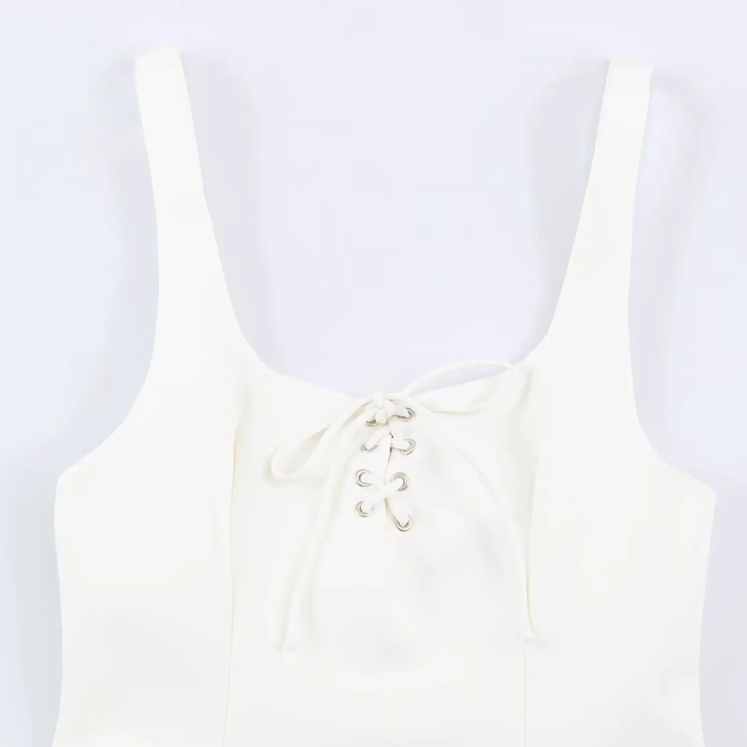 Close-up detail of front eyelet lace-up tie on cream square neck sundress