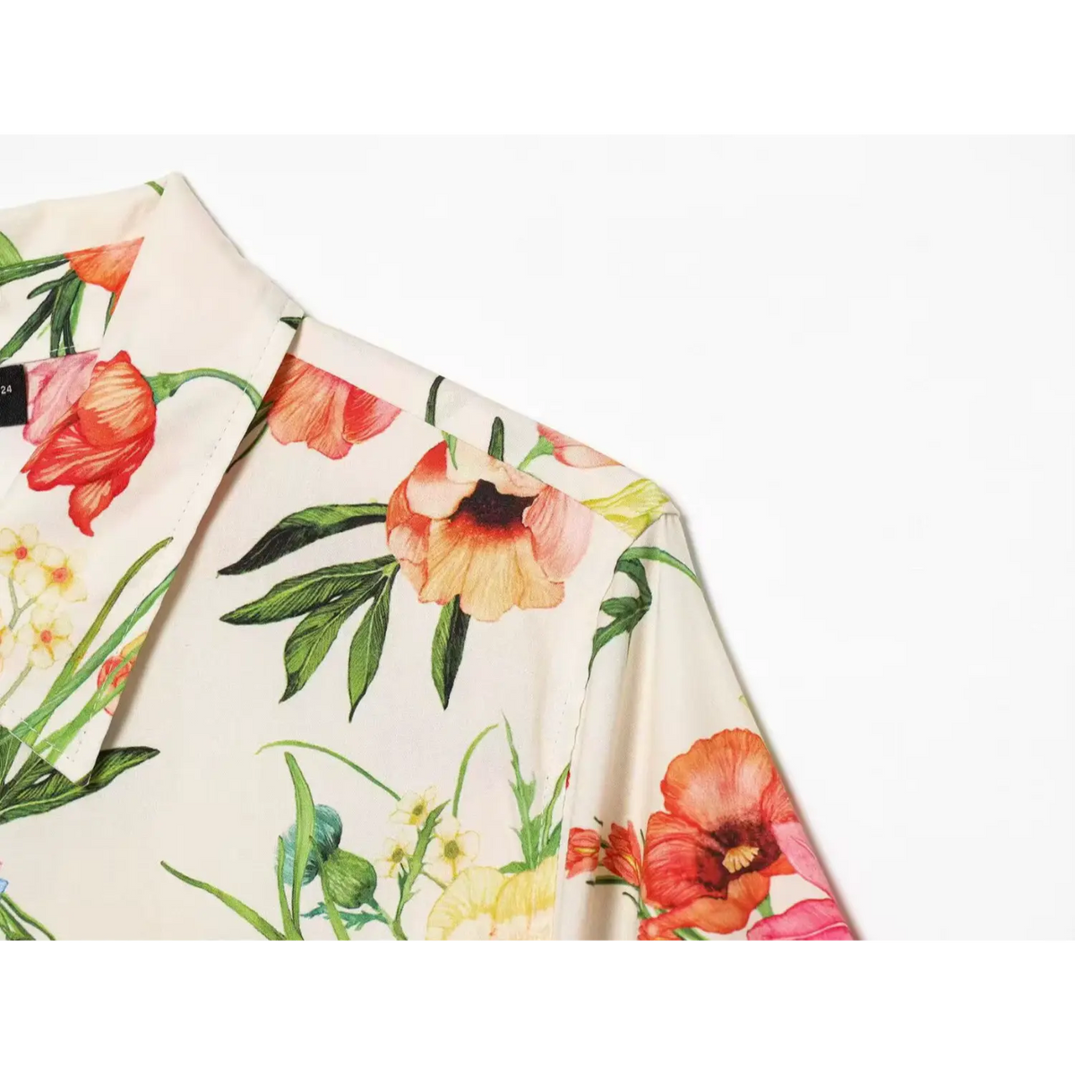 Macro shot of shoulder fabric and watercolor flower print on cream midi dress