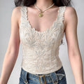 Model wearing cream floral embroidered corset top, v‑neck scallop edge fitted waist silhouette