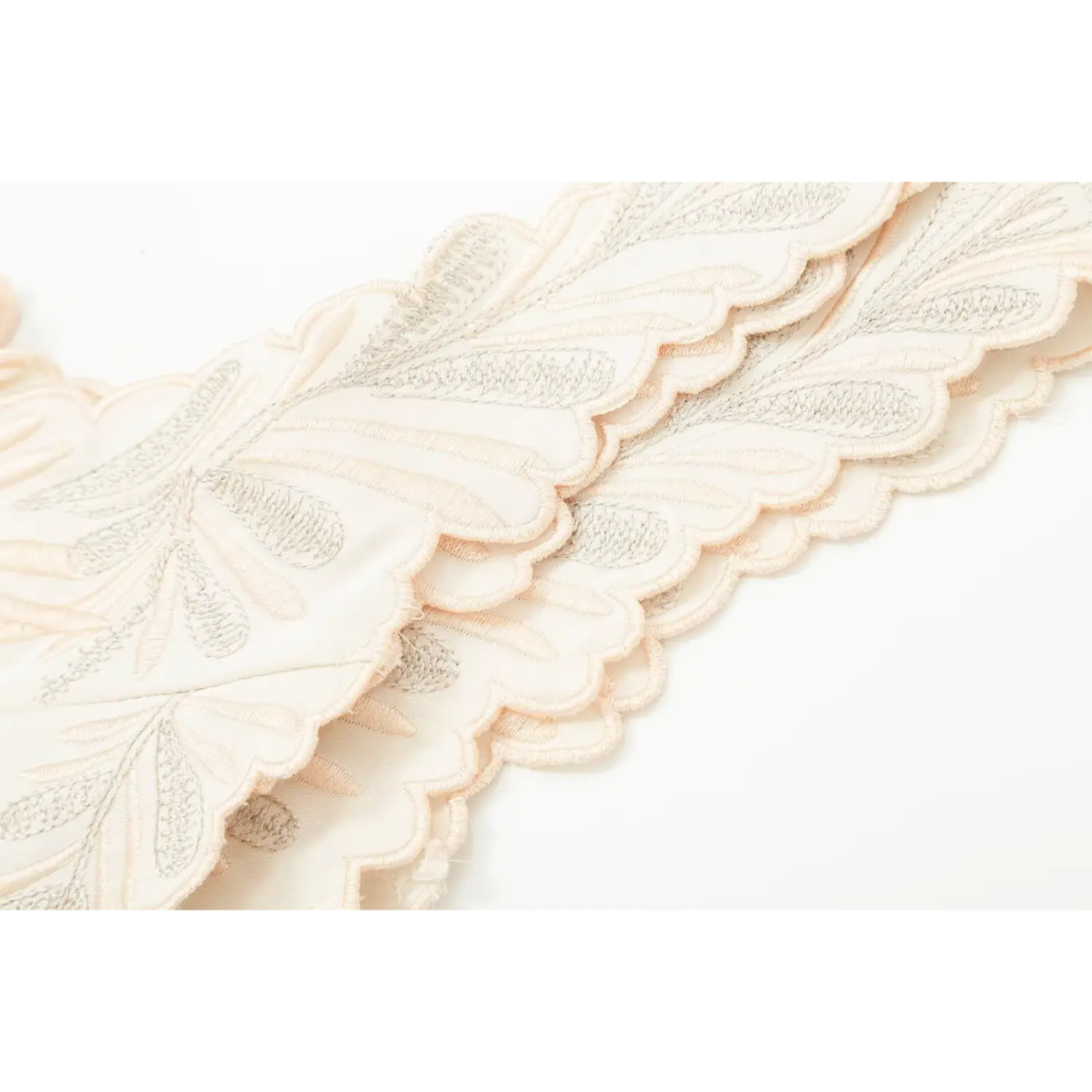 Scalloped embroidered trim close‑up, cream corset top floral stitched edge detail