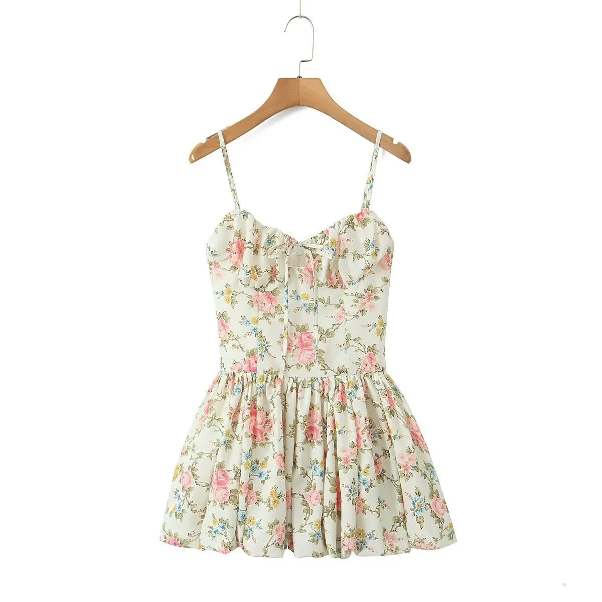 Full front view of the cream floral cami dress on a wooden hanger.