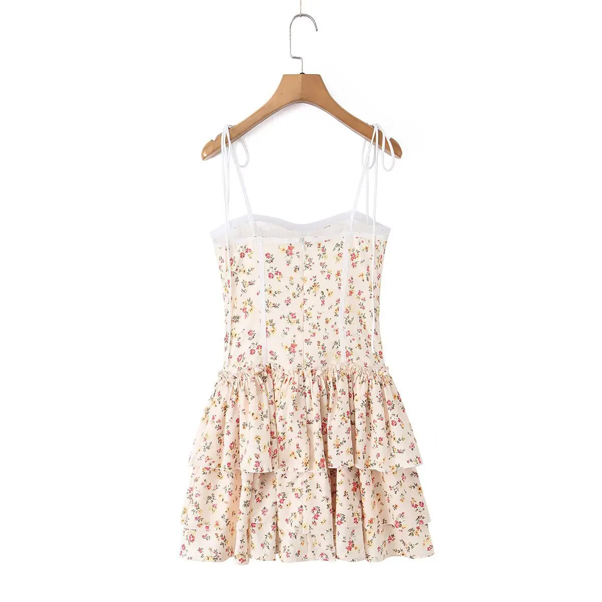 Cream floral print tiered cami dress hanging on wooden hanger, full back view