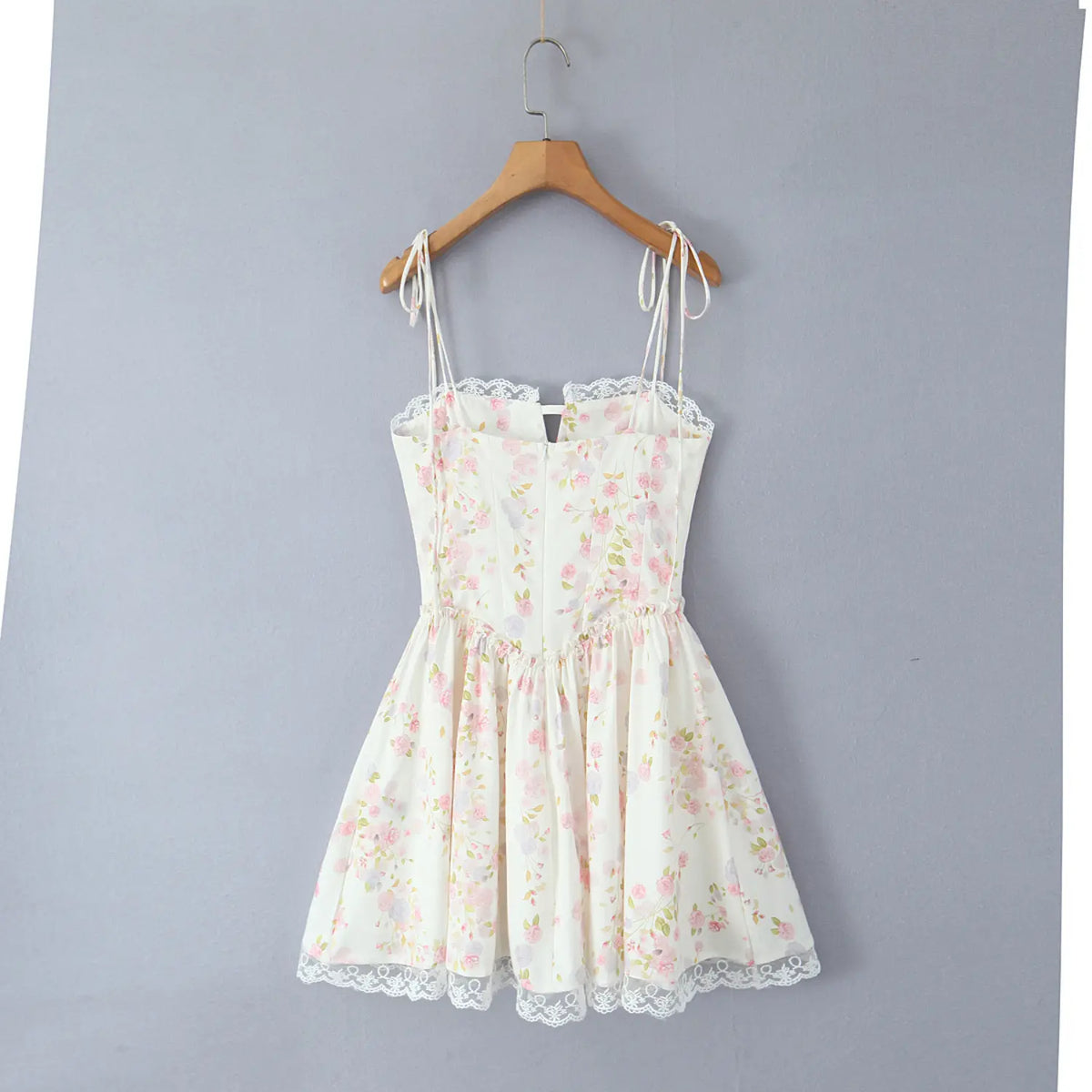 Cream floral corset mini dress, wooden hanger display, back view with hidden zipper