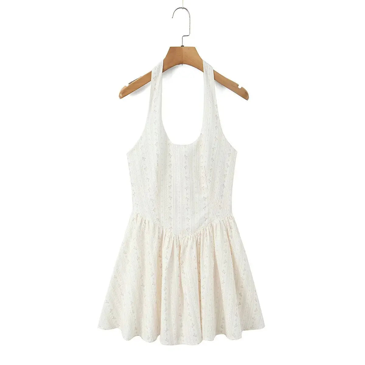 Cream floral halter dress hanging on wooden hanger, front view