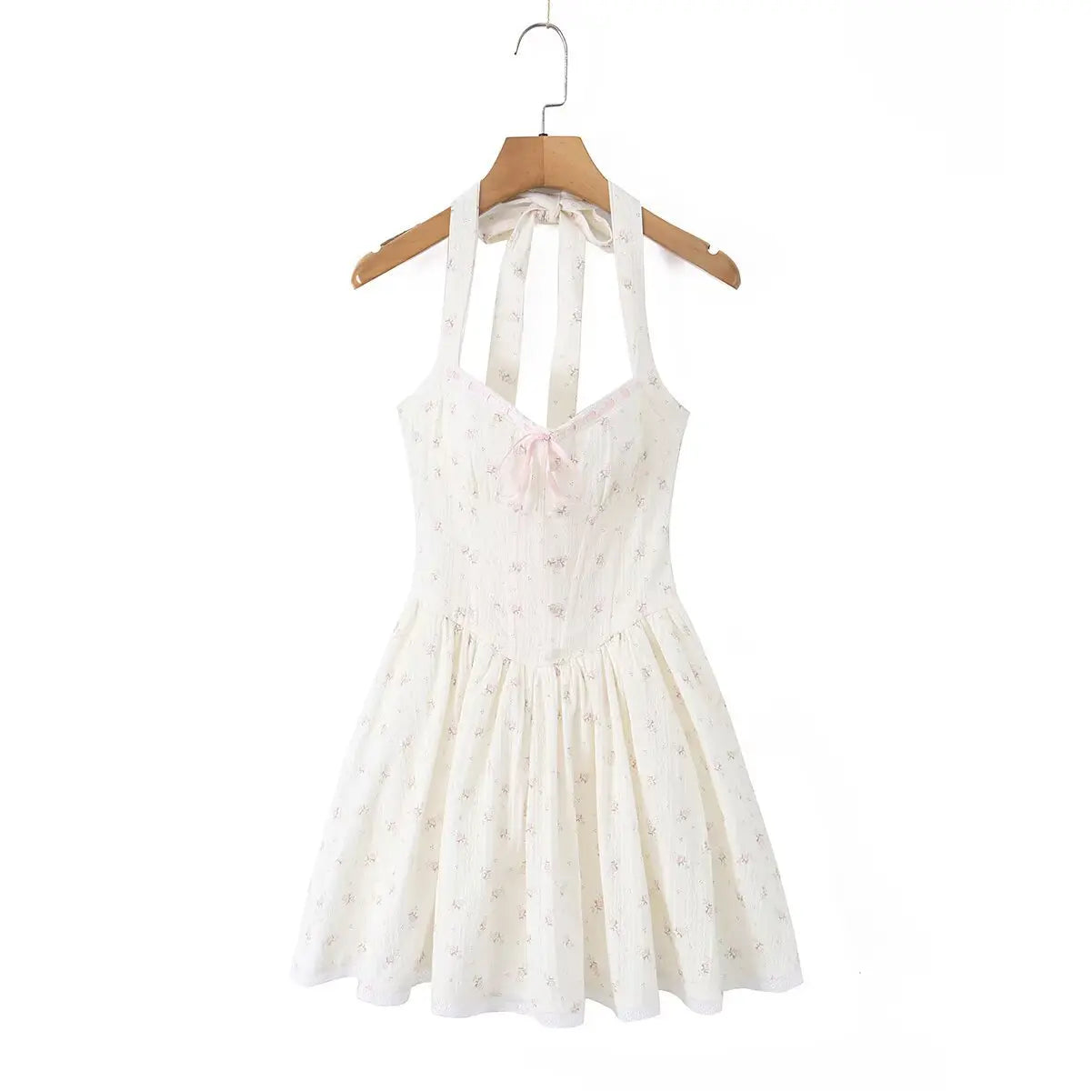 Cream floral print halter mini dress hanging on wooden hanger, front view