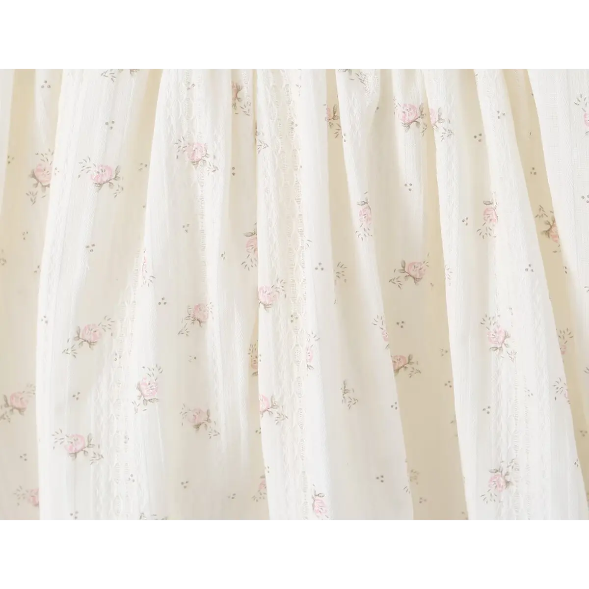 Close-up of the floral print and lightweight fabric texture on the cream halter dress skirt