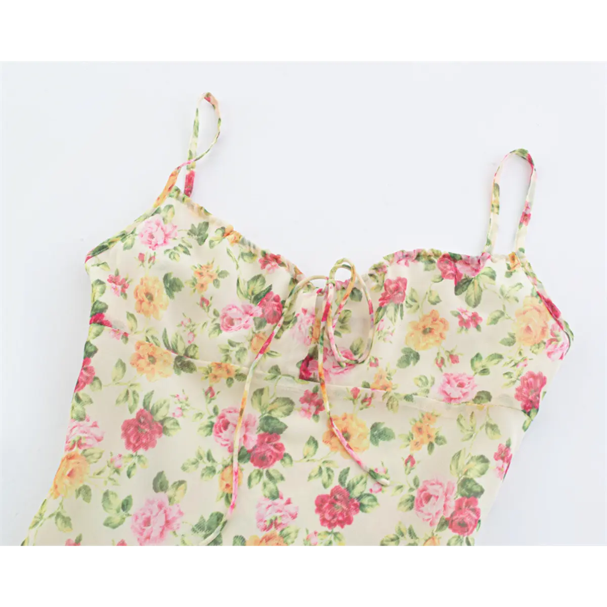 Close-up front view of the bust and tie detail on the cream floral maxi dress.