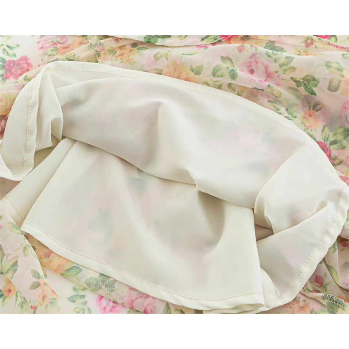 Close-up of the inner lining and fabric construction on the cream floral maxi dress.