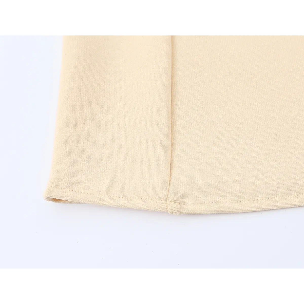 Close-up of the cami's bottom hem, showing the stitching and structured panel construction