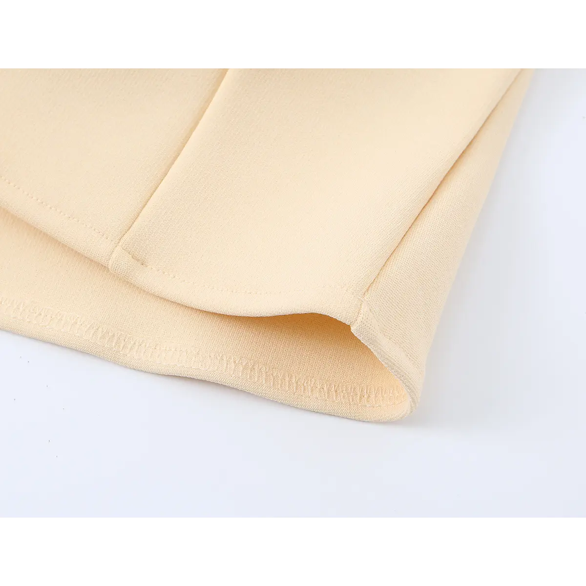 Close-up of the cami's hem, showing the blind stitching and structured panel construction