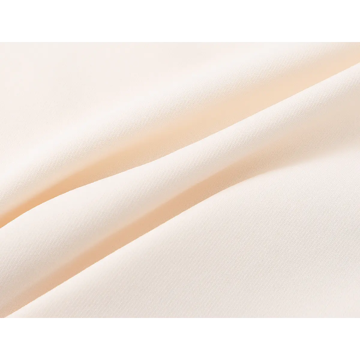 Close-up of the smooth, soft cream-colored fabric of the dress, showing its fine texture and slight sheen.