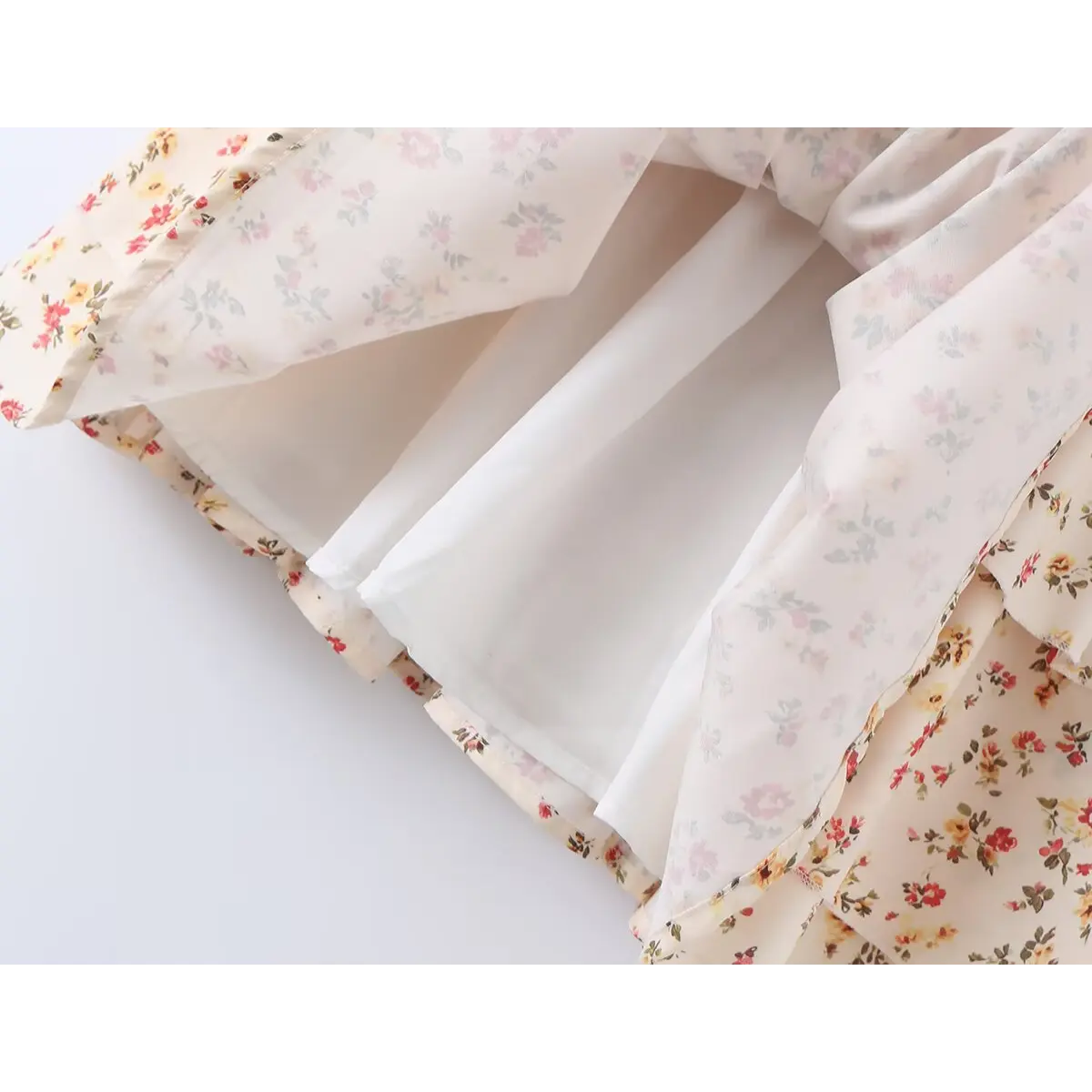 Close-up of the inner lining and layered tiered skirt on the cream floral dress
