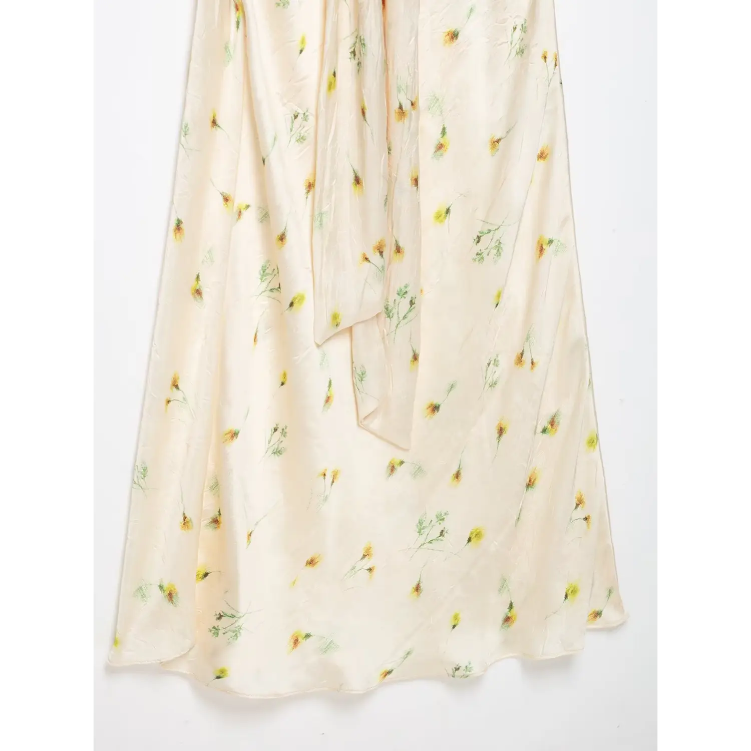 Flowy maxi skirt hem detail, wrinkled textured satin with scattered yellow floral print