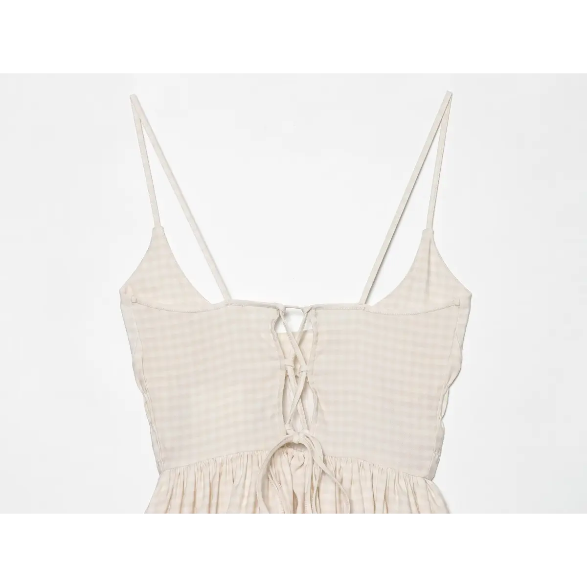 Close-up of the back lace-up tie detail on the cream gingham cami dress
