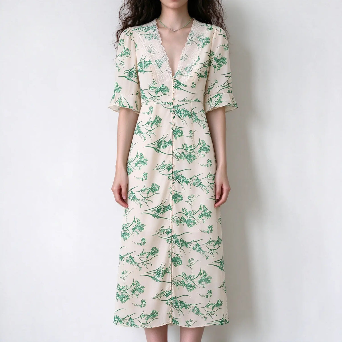 Model wearing cream green botanical floral v-neck maxi dress with lace trim, short flared sleeves and front buttons, white background
