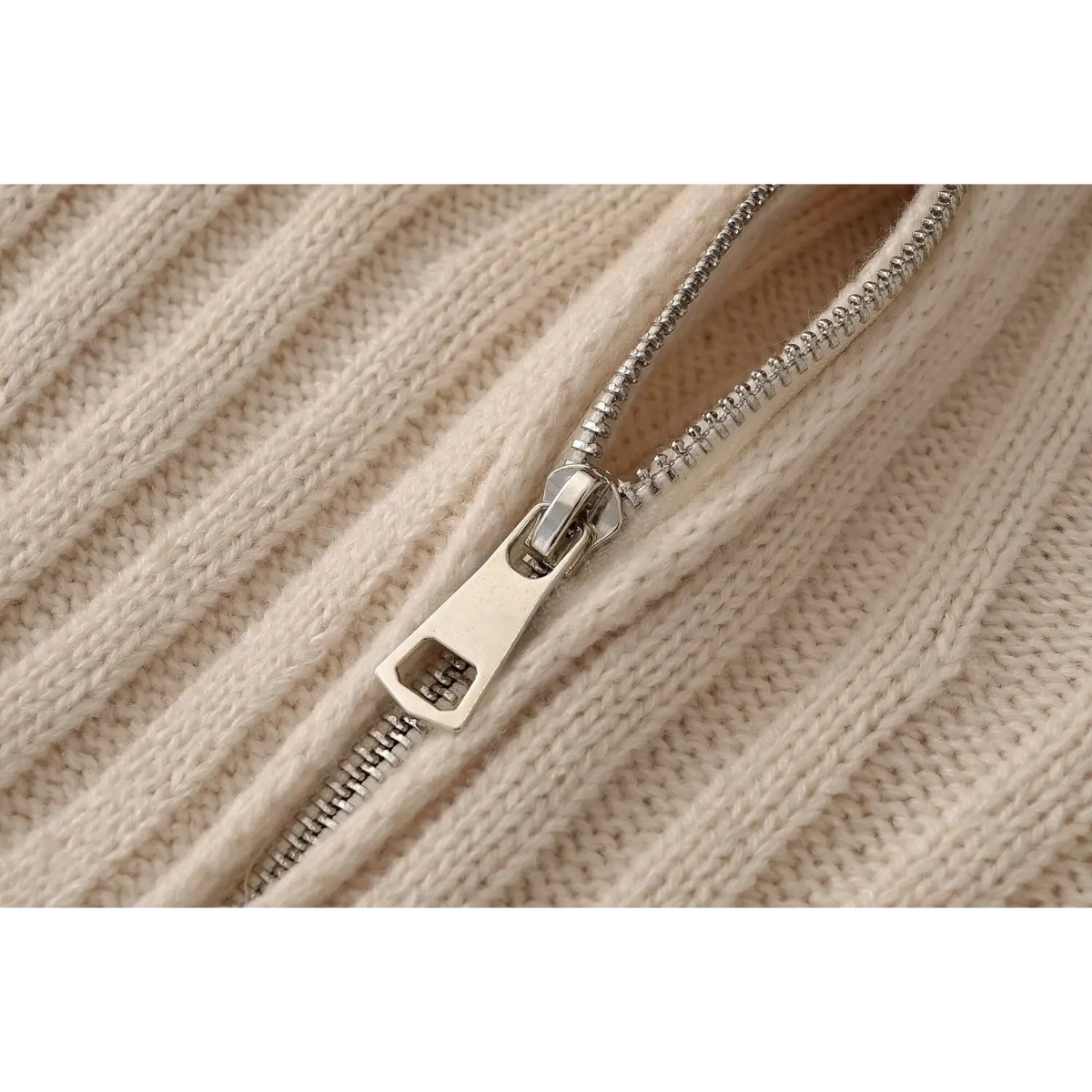 Close-up of metal zipper teeth and ribbed knit