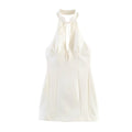 Front flat lay view of cream halter mini dress, stand collar, front tie keyhole, fitted seamed silhouette