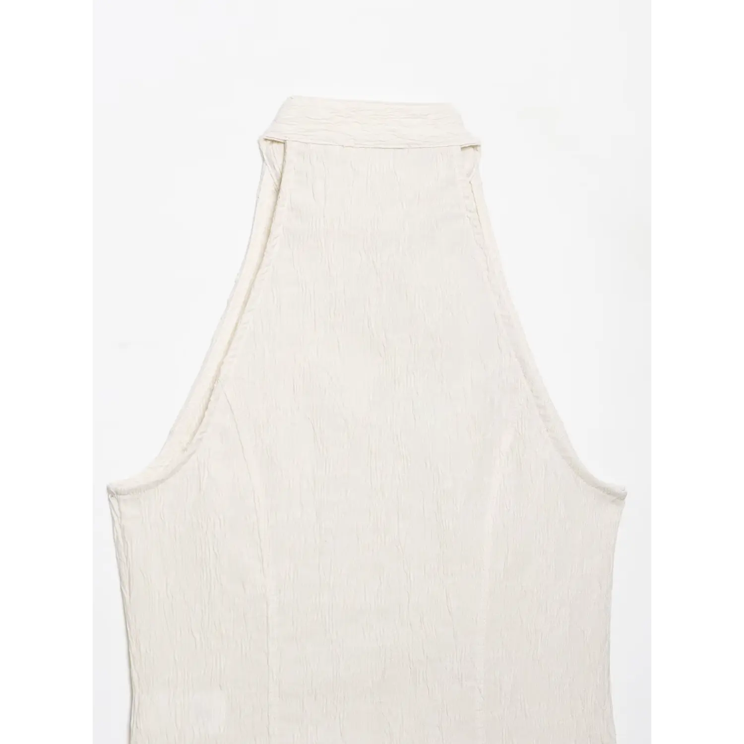 Full flat‑lay back view showing collar and shoulder seam of cream textured halter top