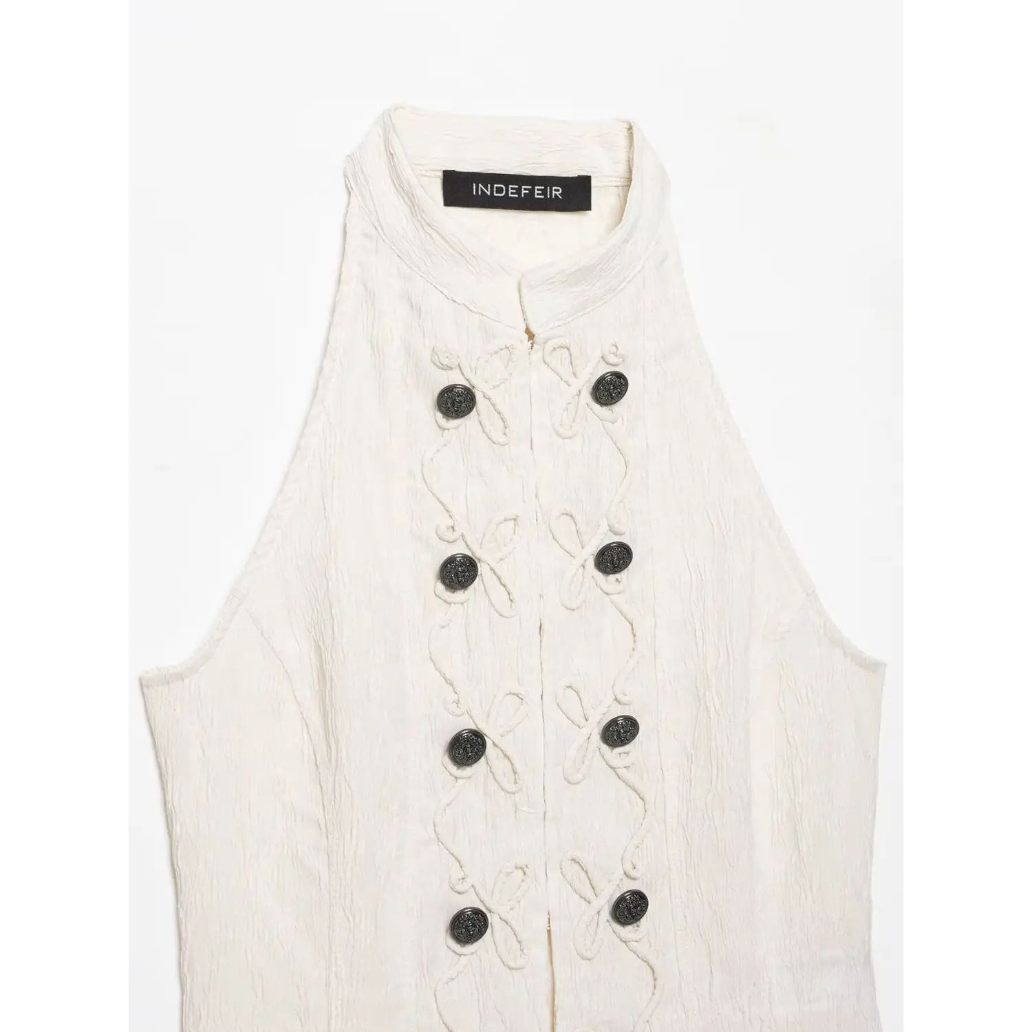 Close‑up full front panel cream halter top, show rope embroidery and double row black decorative buttons