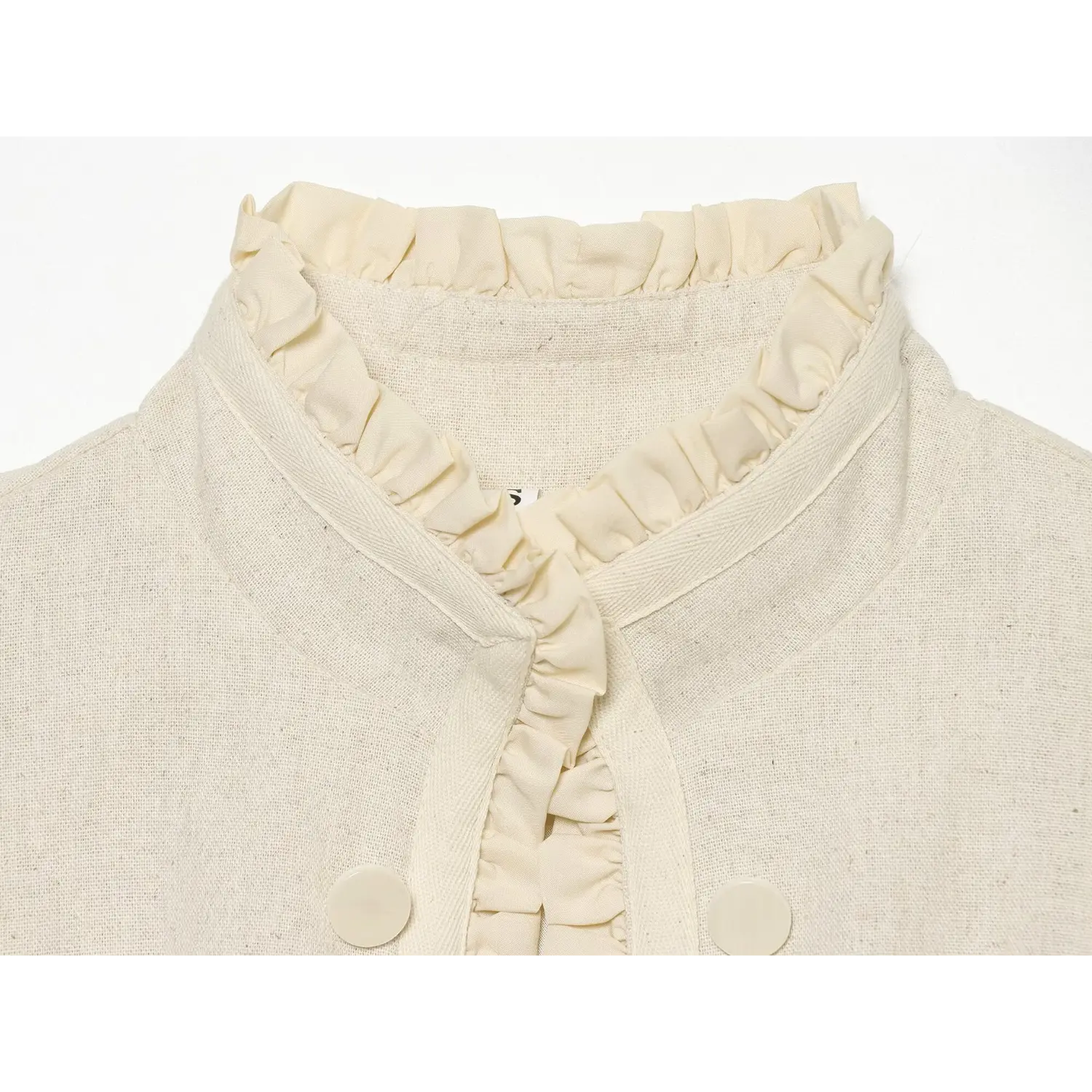 Macro close‑up of ruffled stand collar on cream cropped jacket, textured woven fabric