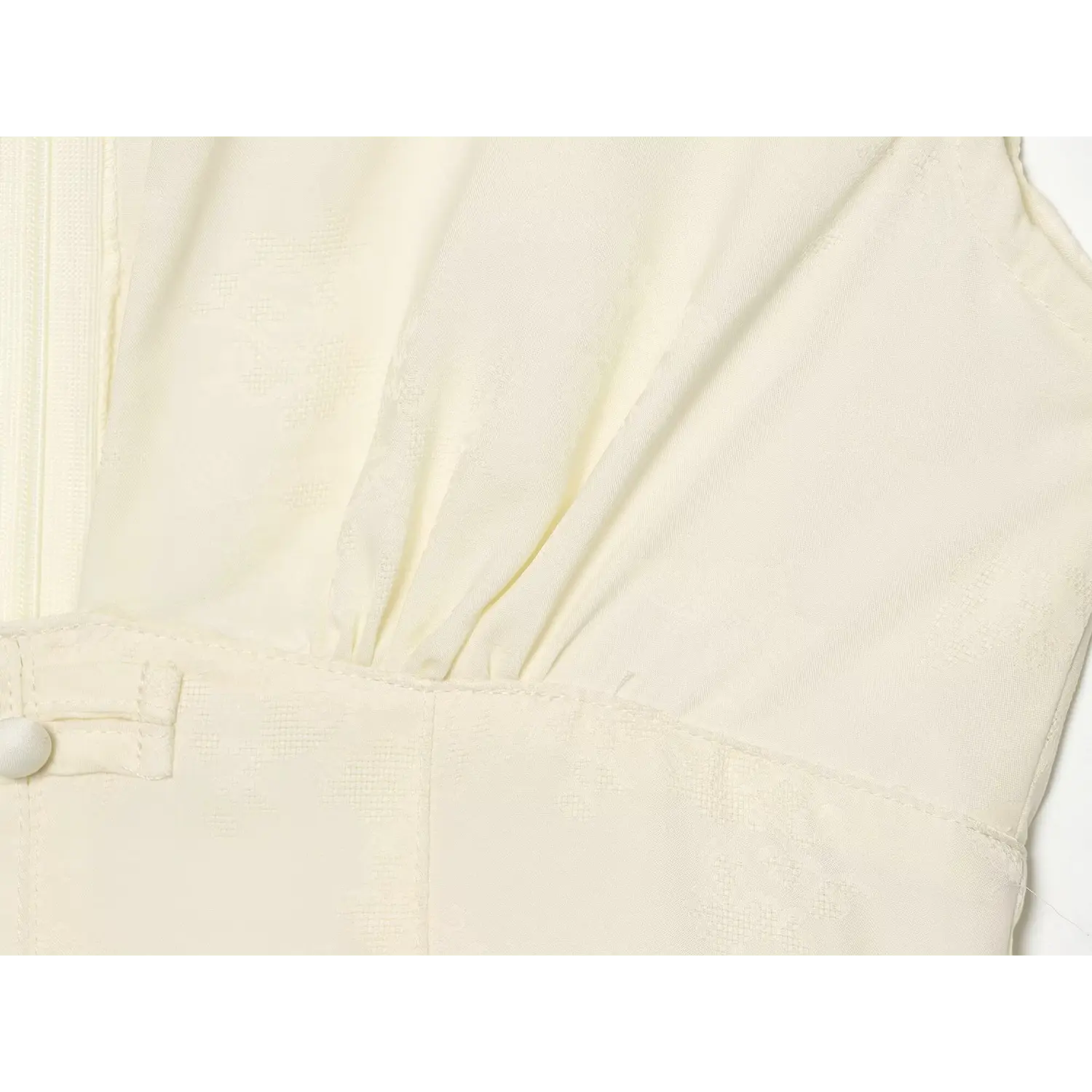 Macro detail gathered bust stitching of cream jacquard mini dress, textured floral woven fabric