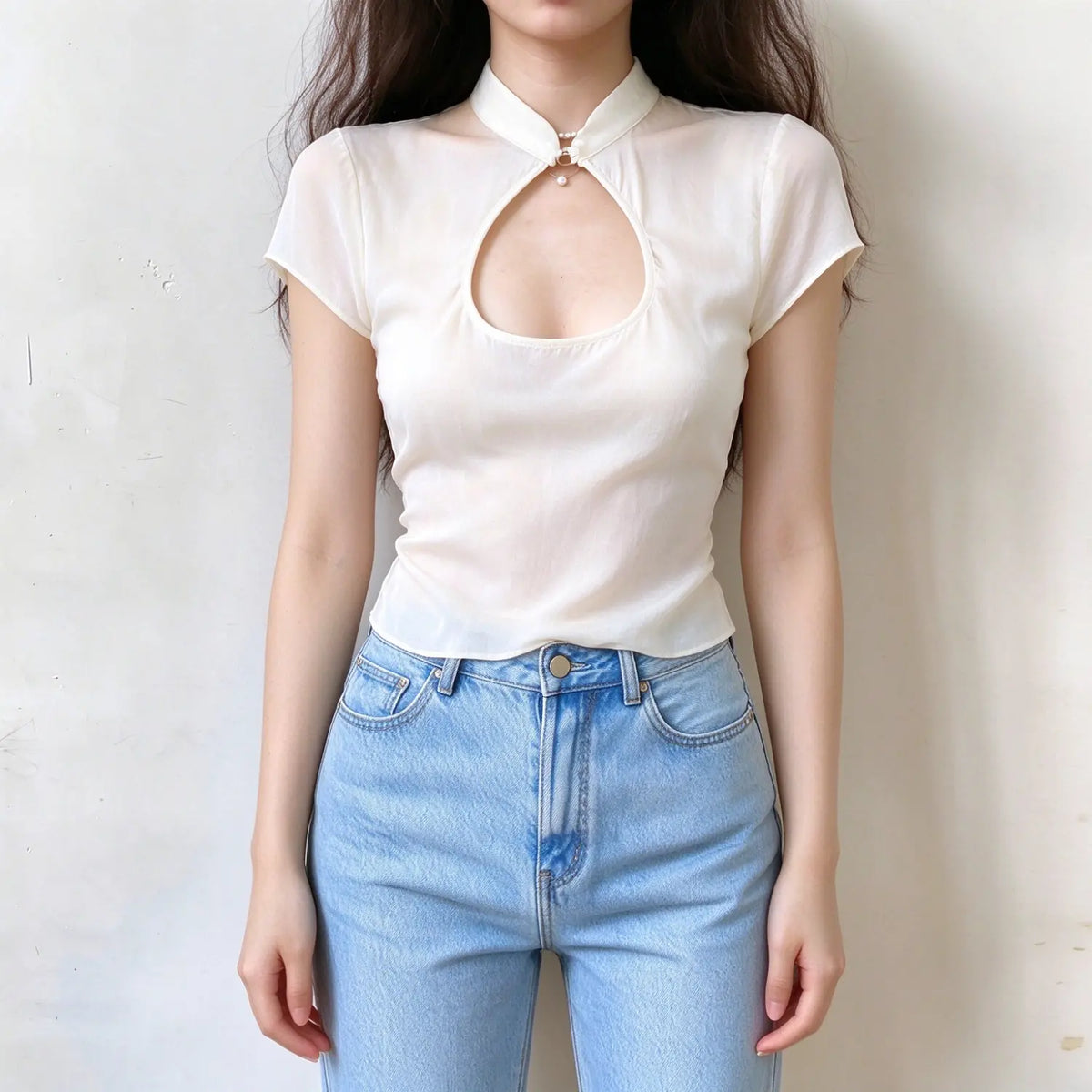 Model wearing cream keyhole short sleeve top, mandarin collar with pearl fastener, front cutout, slim fitted lightweight fabric