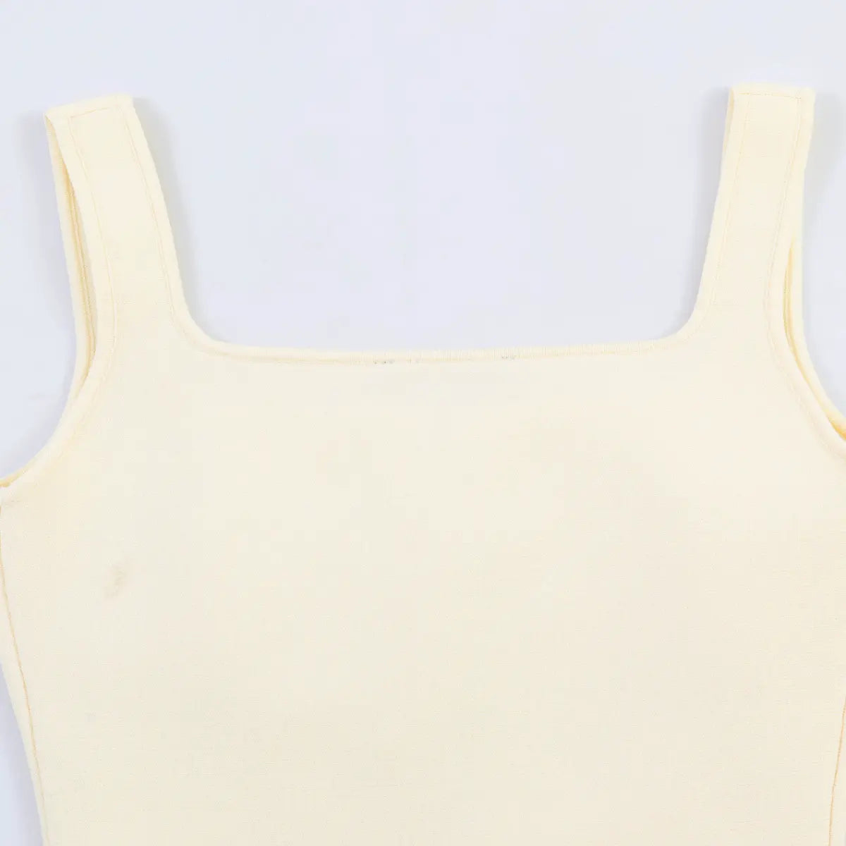 Back view detail of the cream knit tank top, showing the fitted silhouette