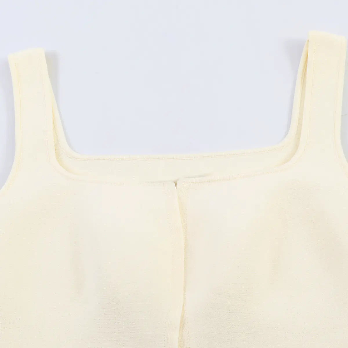 Side view detail of the cream knit tank top, showing the fabric drape and silhouette