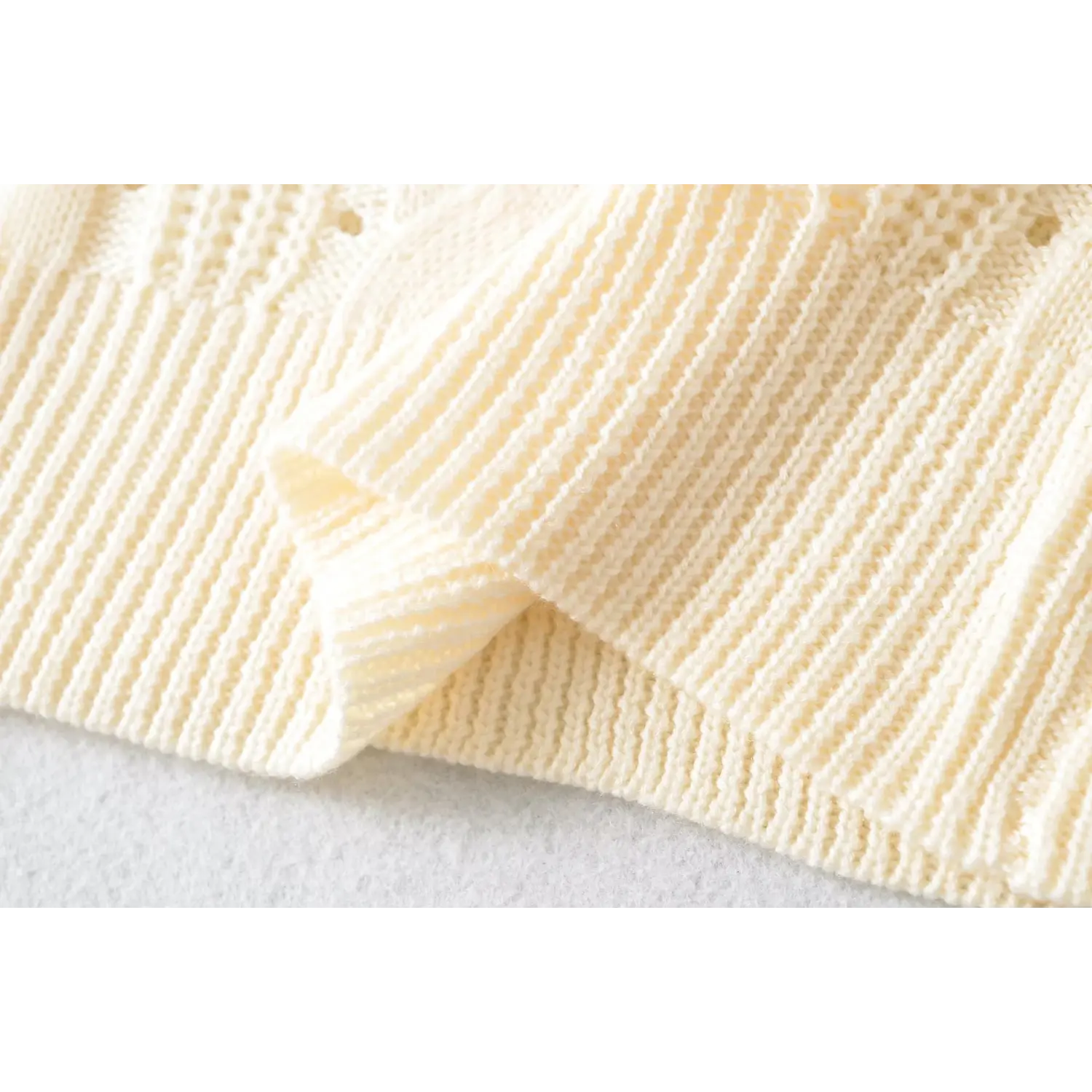 Folded ribbed hem texture close up lightweight cream cable hollow knit women fitted short sleeve top