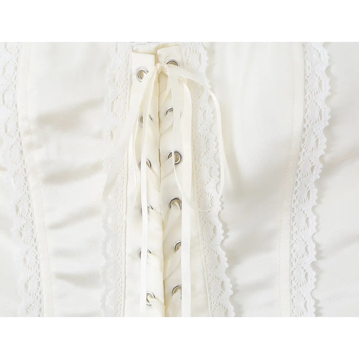 Close-up of the front lace-up detail and eyelets on the cream corset bustier