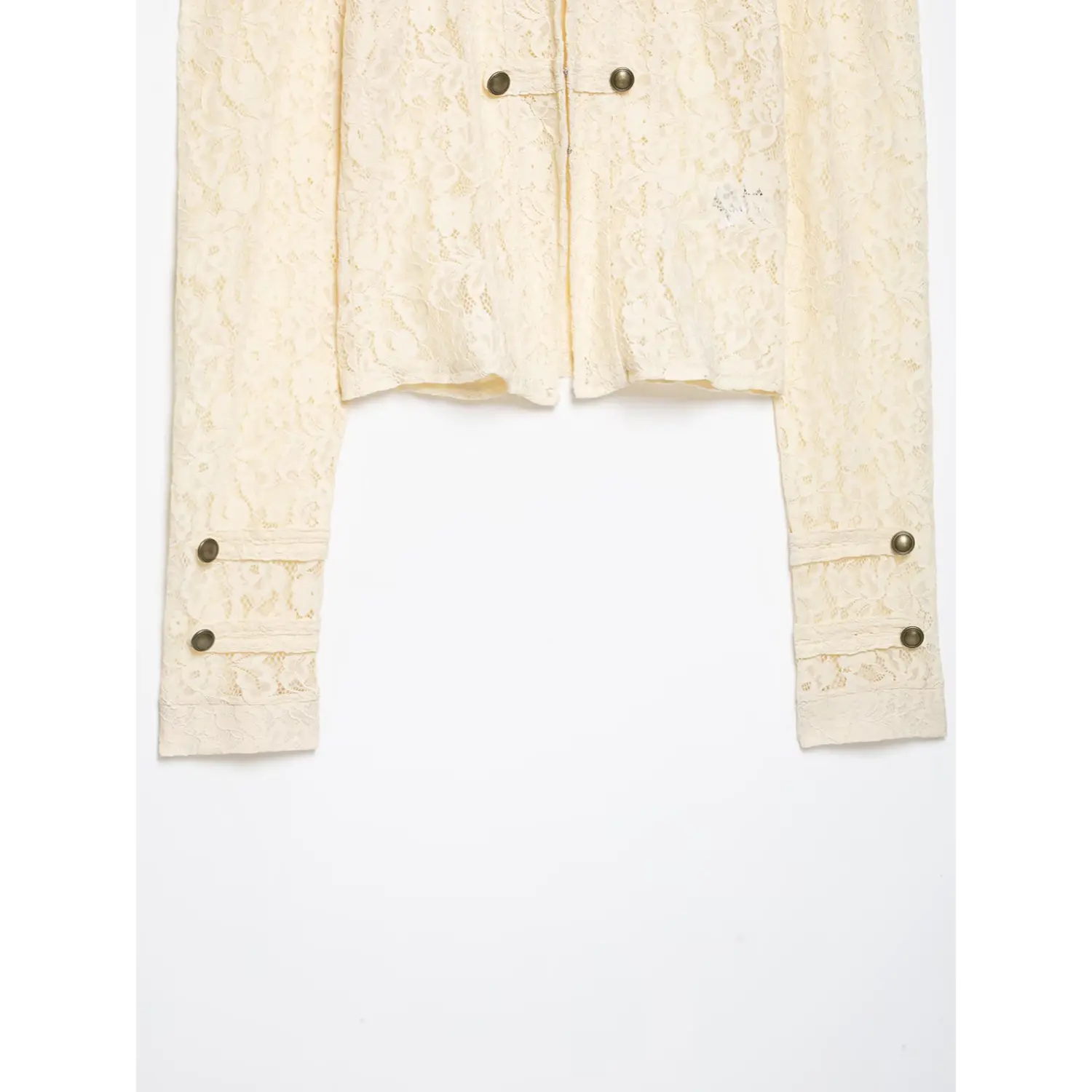 Close‑up front placket of cream lace cropped jacket, stand collar, double breasted antique metal buttons, floral lace