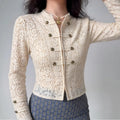 Model wearing cream double‑breasted cropped lace jacket, stand collar antique metal buttons, fitted silhouette, styled outfit