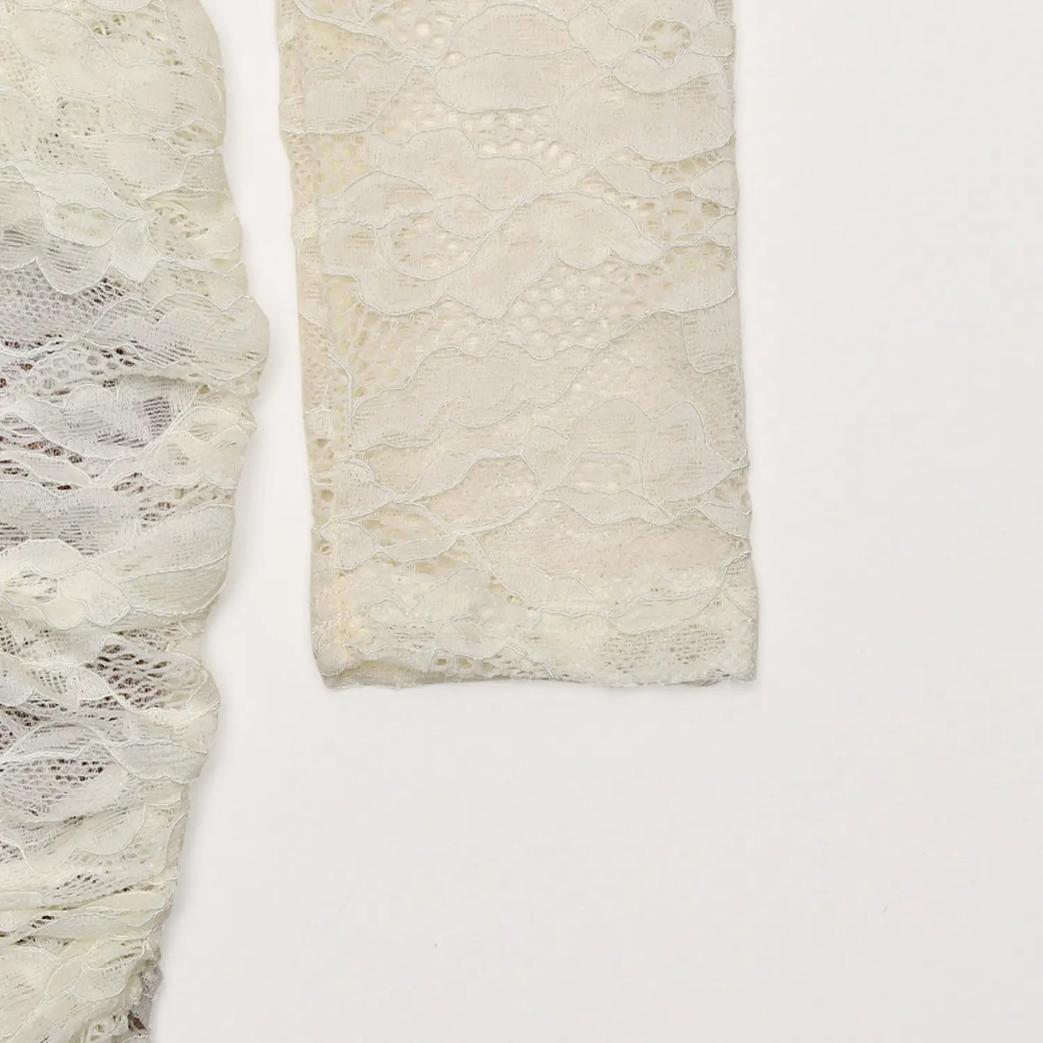 Close up flat lay cream floral lace long sleeve cuff fabric detail