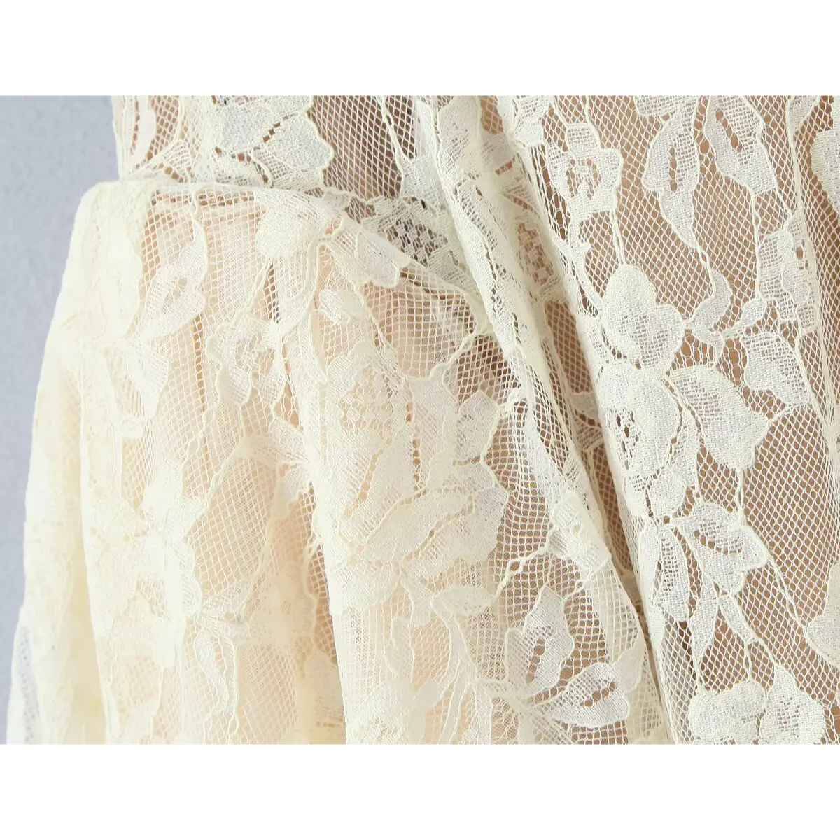  Close-up of the intricate floral lace pattern on the mesh fabric.
