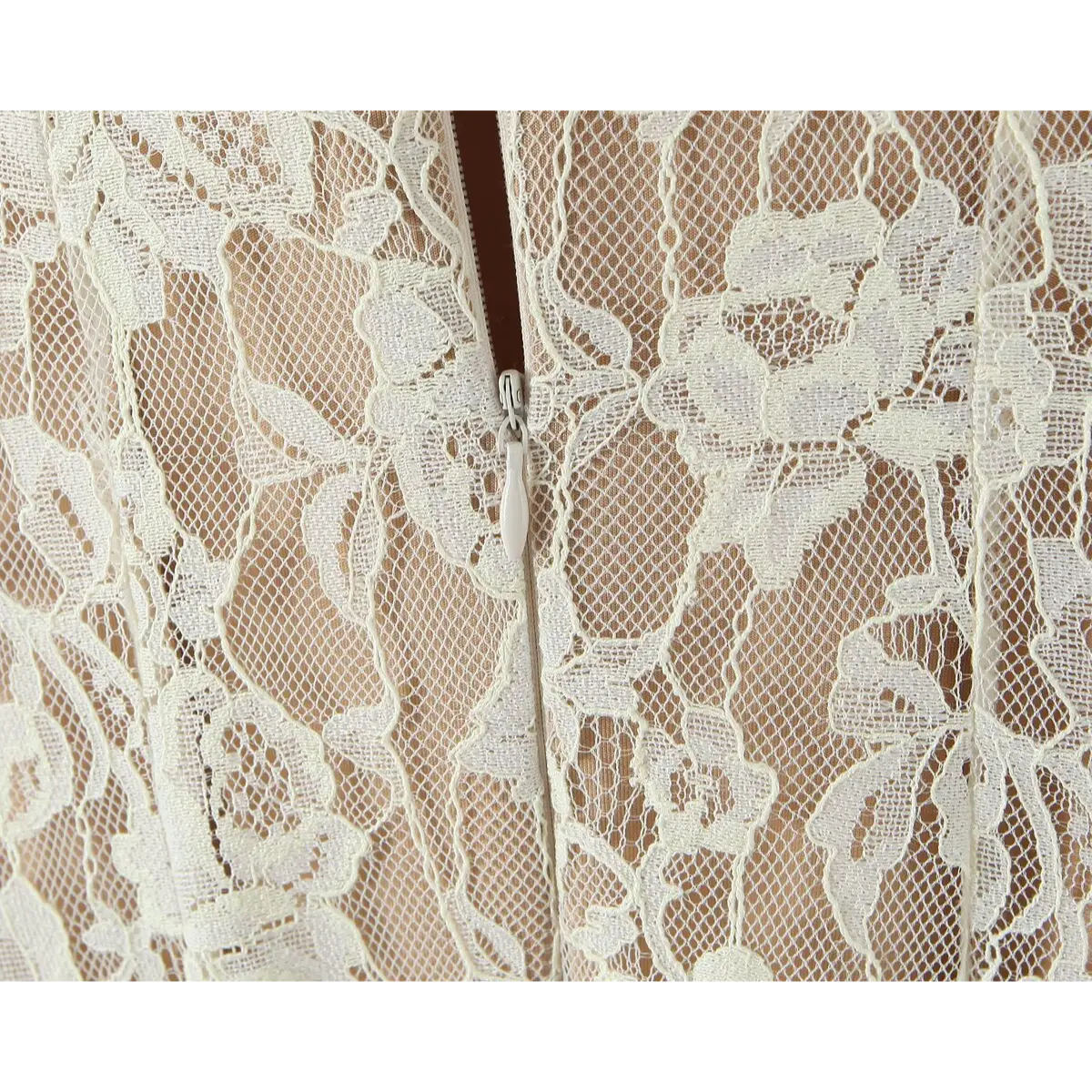 Close-up of the invisible back zipper, seamlessly integrated into the floral lace fabric.