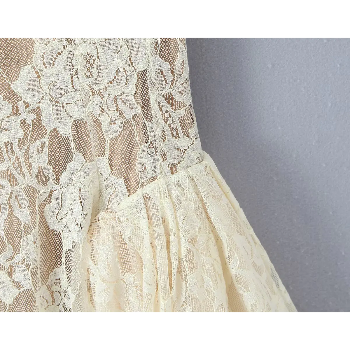 Close-up of the waist seam where the fitted bodice transitions into the gathered, flared skirt.
