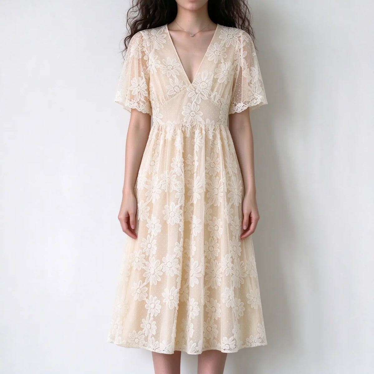 Model wearing cream floral lace short sleeve v-neck maxi dress with empire waist and scalloped hem, white background