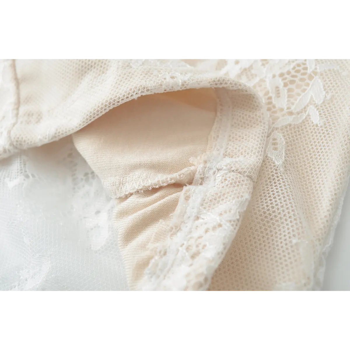 Close-up of the inner lining and construction of the cream lace halter top.