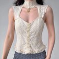 Model wearing cream embroidered lace sleeveless top, high smocked neck, sweetheart V front, ruffle hem, fitted waist