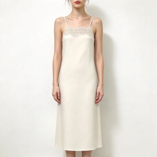 Model wearing cream slip maxi dress, delicate lace trim at square neckline, thin spaghetti straps, straight relaxed maxi skirt, white backdrop