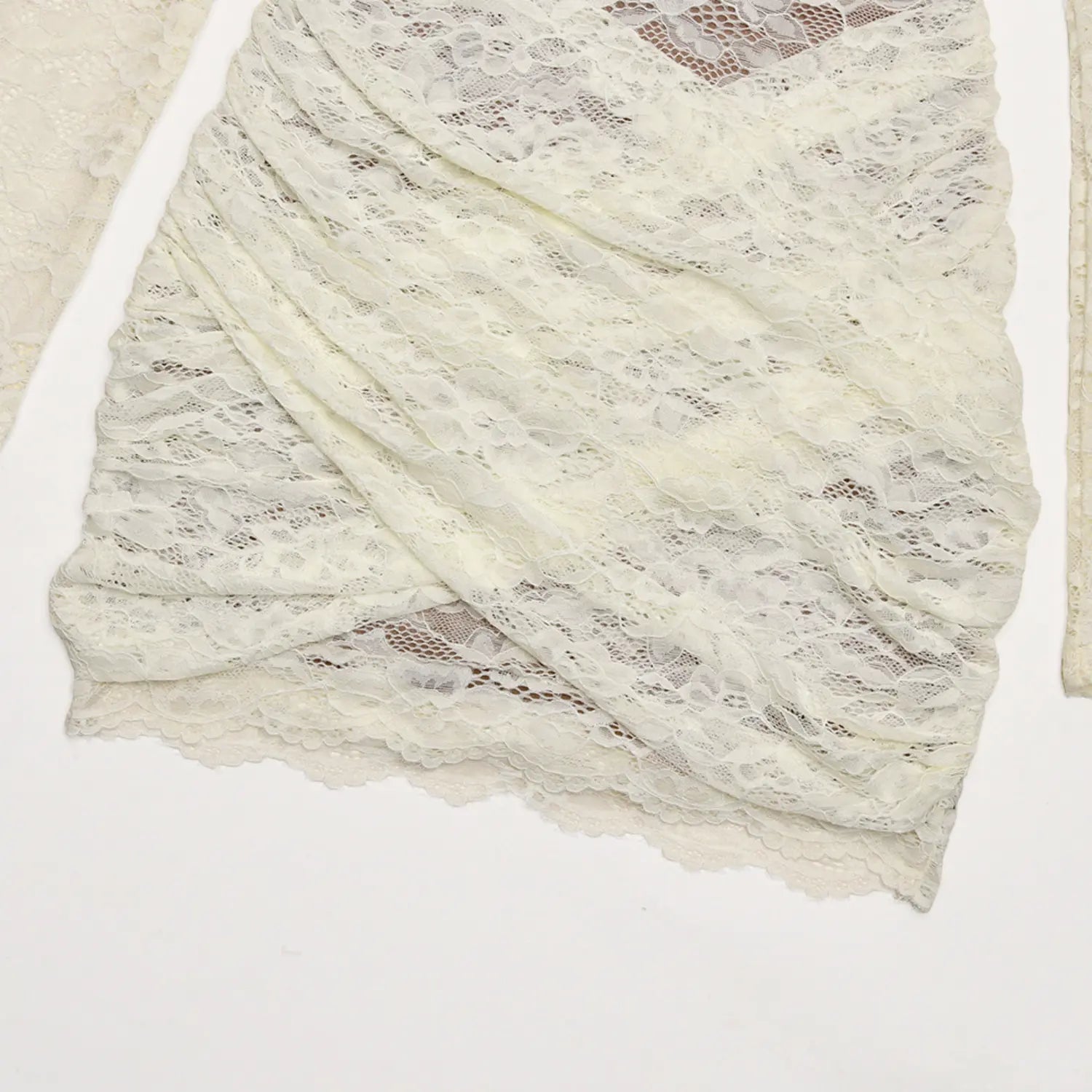 Flat closeup cream sheer lace crossover wrap ruched skirt fabric detail