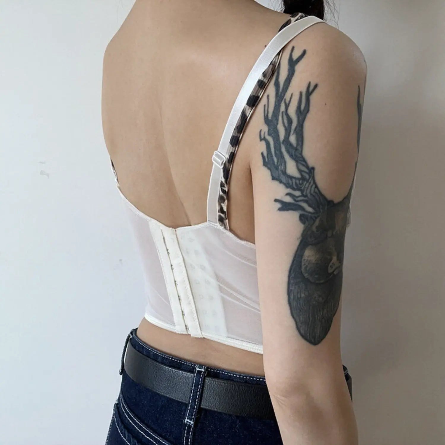 Cream leopard lace corset tank full back model shot, full sheer mesh multi-adjust hook back pink bone hem, matched with denim shorts soft casual outfit display