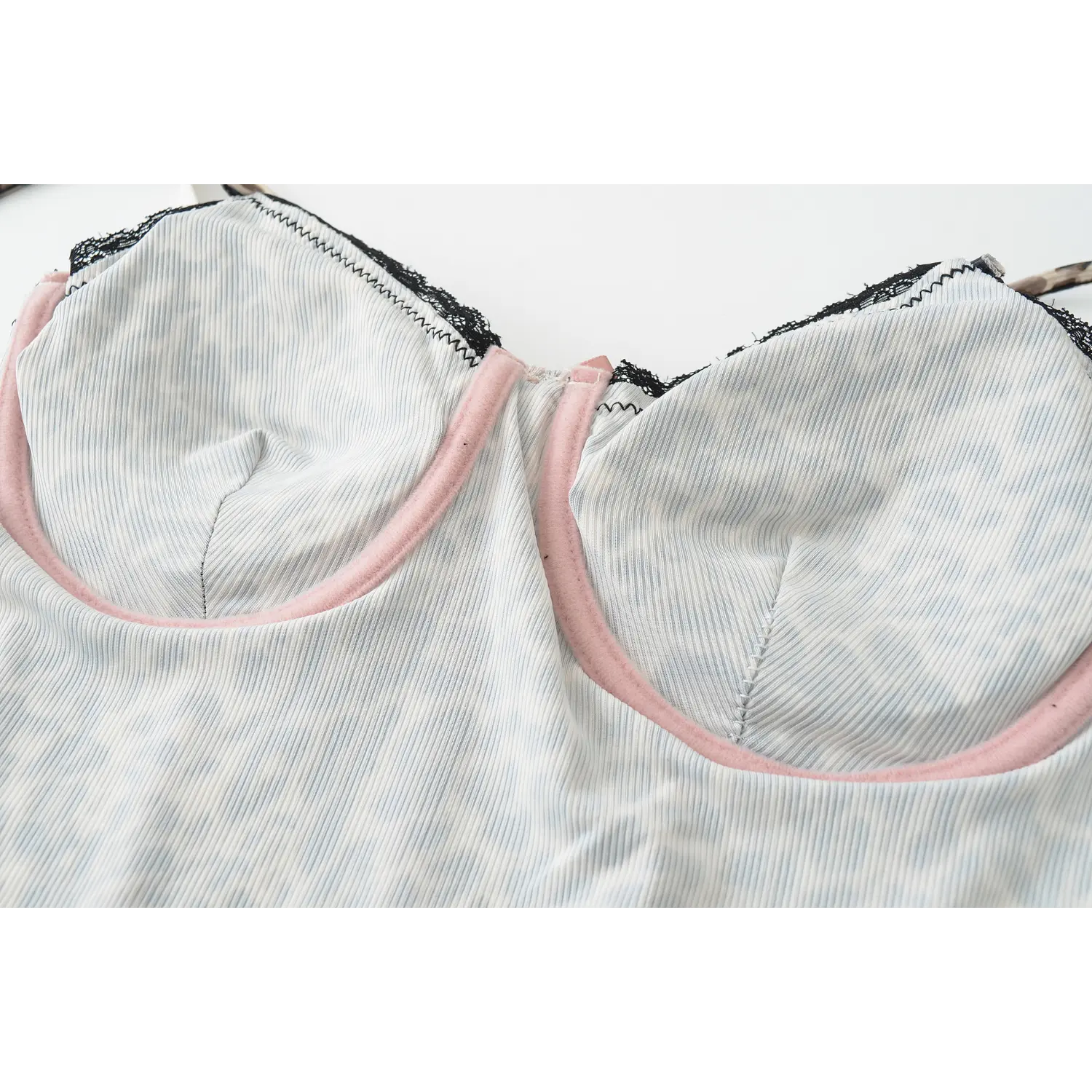 Cream leopard lace corset tank inner molded cup lining flat close-up, vertical rib leopard print inner fabric pink soft trim neat stitching white background shot