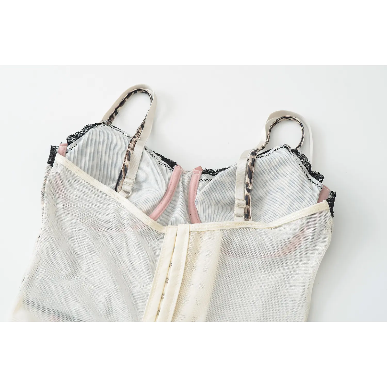 Cream leopard lace corset tank inner back flat close-up, multi-row adjustable metal hook sheer mesh lining pink trim bone support stitching white background shot