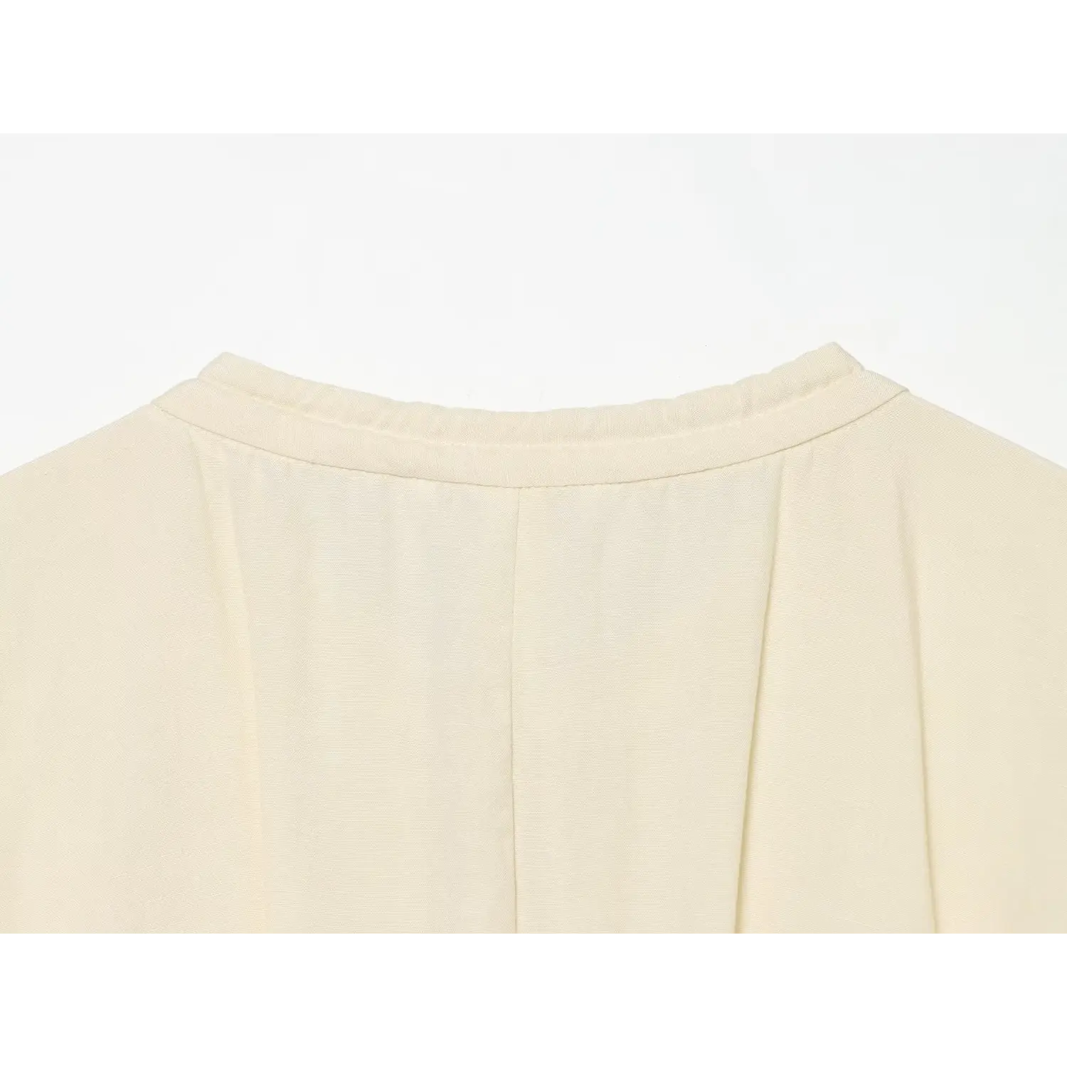 Close‑up back collar view of cream linen blend maxi dress with gathered neckline stitching