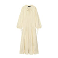 Cream linen blend maxi dress front view, tie neck, balloon long sleeves with cuff ties, flowy long skirt